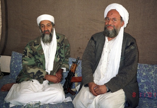 Osama bin Laden (L) sits with his eventual successor Ayman al-Zawahiri